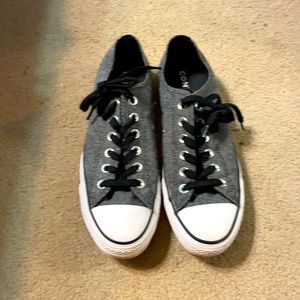 Lightly warn grey and black converse.